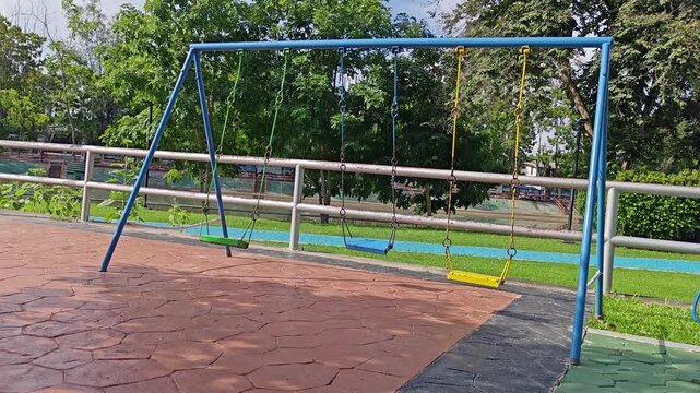 A metal swing in the park.