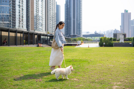 Pregnant woman walking dog in Hong Kong park