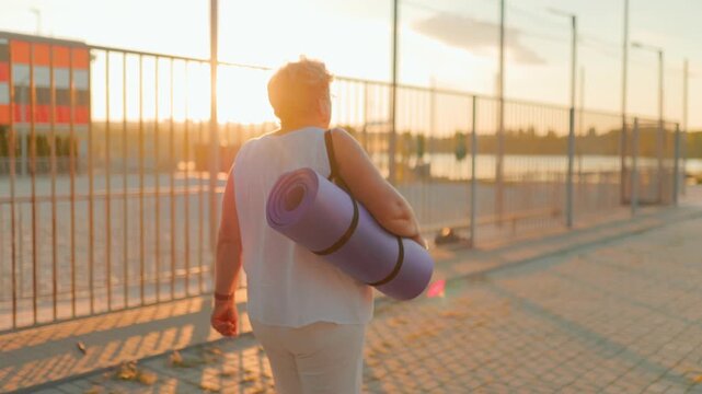 Overweight pensioner strolling towards morning outdoor workout. fitness and healthy