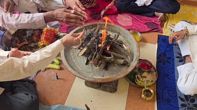 Sacred havan fire ritual performance with ceremonial items a group of people sitting around