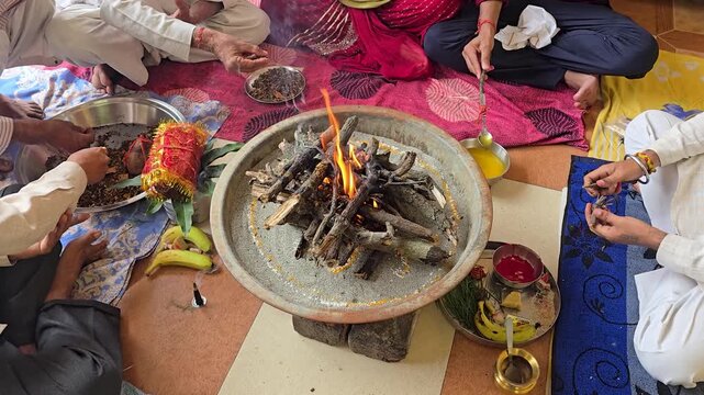 Performing traditional hindu havan ritual ceremony participants engage in a sacred fire ceremony
