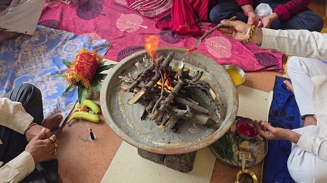 Traditional havan kund fire ceremony ritual close up of a showing the sacred flames, wooden logs
