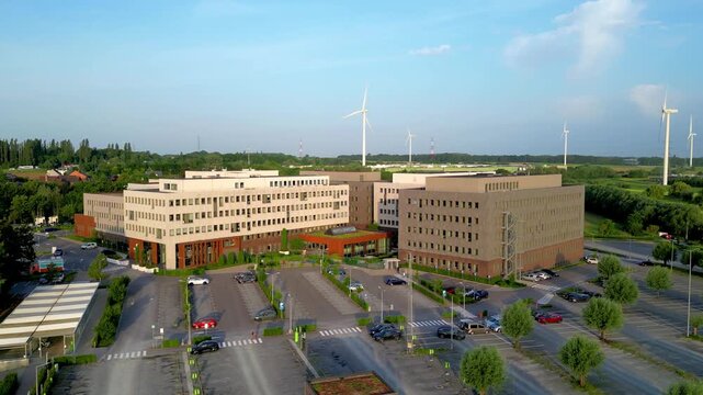 Aerial View of Modern Corporate Headquarters with Wind Turbines for Sustainable Energy