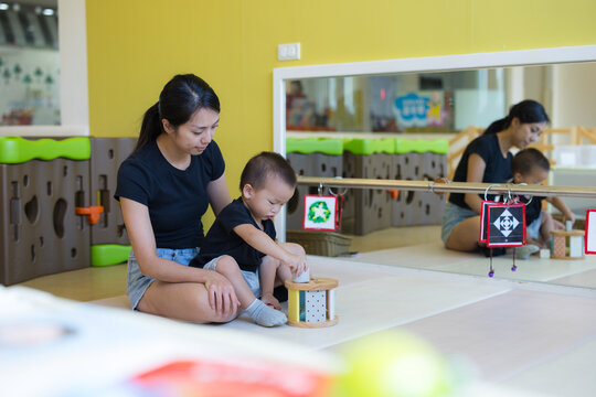 Mother and child playing with educational toy