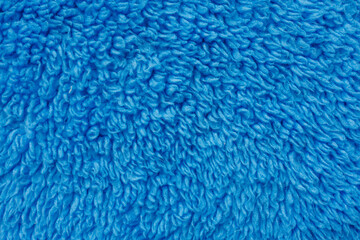 Blue fluffy fabric forms dense textile texture © Iryna Miadzvedzeva