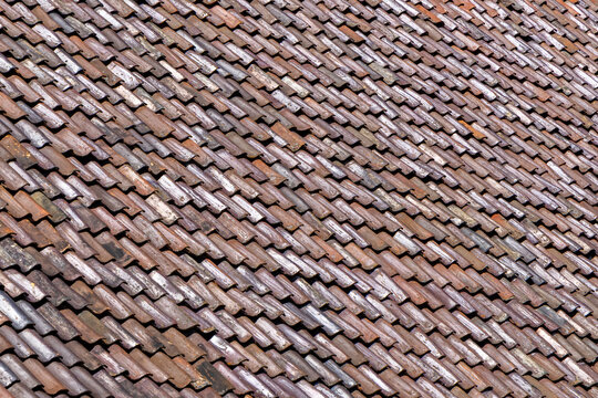 background of wooden grey shingles in harmonic structure at a farm house in grazing light