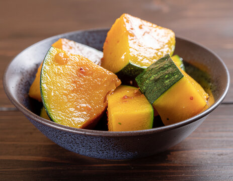 Japanese simmered kabocha pumpkin in a blue ceramic bowl traditional home cooking
