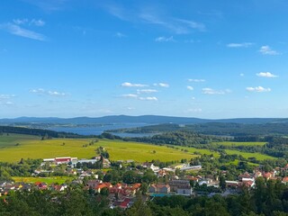 Fototapeta premium Green alpine meadows in Lipno, Czech Republic, surrounded by beautiful natural landscape.