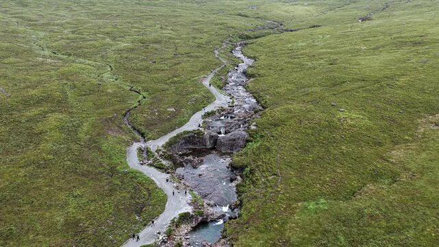 Aerial drone view of the Fairy Pools on the Isle of Skye, Scotland, featuring crystal-clear pools, waterfalls and mountain scenery.