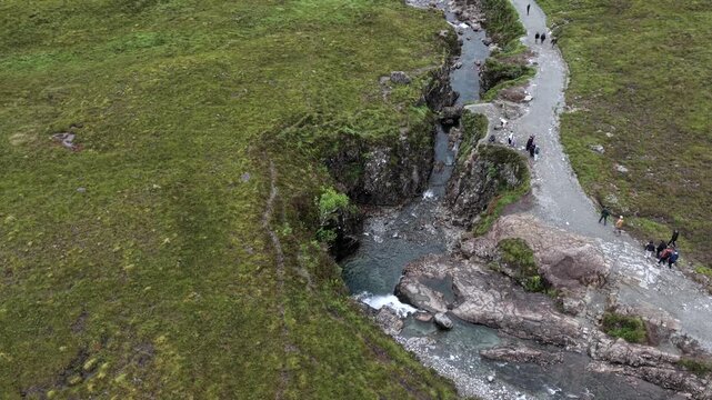 Aerial drone view of the Fairy Pools on the Isle of Skye, Scotland, featuring crystal-clear pools, waterfalls and mountain scenery.