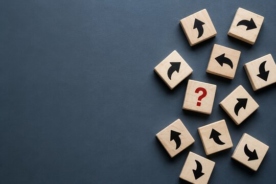 Scattered wooden blocks with arrows and a single block showing a question mark