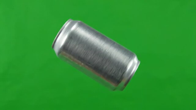 Generic aluminum beverage can rotating and floating against a bright green screen background for chroma key compositing