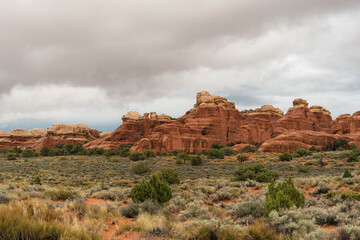 Clouds drift above rock formations near the Devils Garden Trail at Arches National Park, Utah © LB Photo Co