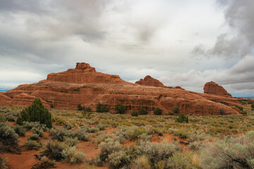 Clouds drift above rock formations near the Devils Garden Trail at Arches National Park, Utah © LB Photo Co