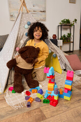 Joyful moments of a boy exploring creativity at home © LIGHTFIELD STUDIOS