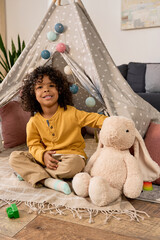 Joyful moments of a young boy playing with toys at home in a cozy setting © LIGHTFIELD STUDIOS
