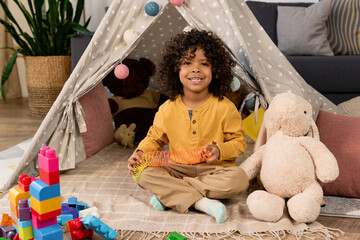 Joyful moments of a boy playing at home in a cozy modern apartment © LIGHTFIELD STUDIOS