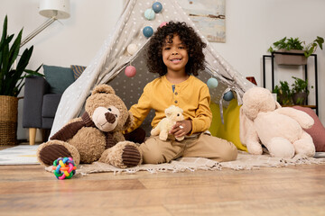 Happy moments of a joyful boy playing in a cozy modern apartment © LIGHTFIELD STUDIOS