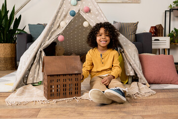 Happy moments of a joyful boy playing in a cozy modern apartment © LIGHTFIELD STUDIOS