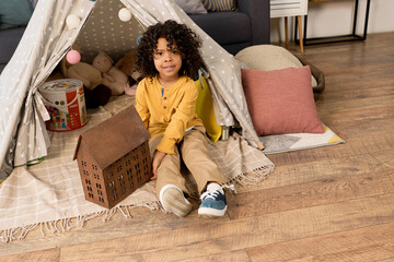 Happy african american boy enjoying playtime in a cozy modern apartment © LIGHTFIELD STUDIOS