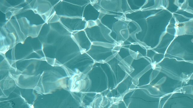 Abstract blue water texture with shimmering sunlight reflections creating a calm pool background. Seamless aquatic surface, perfect as a natural water background and summer design texture.