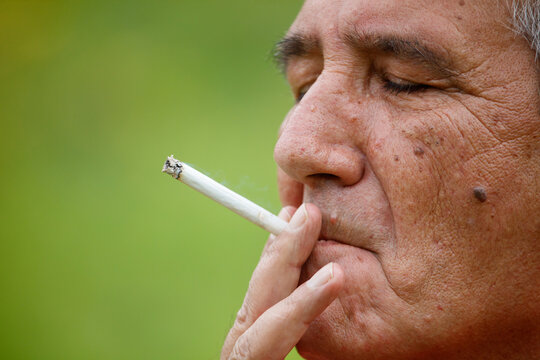 Man smokes cigarette outdoors