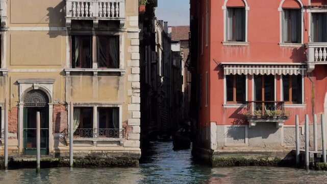 Traditional gondola gliding through narrow Venetian canal