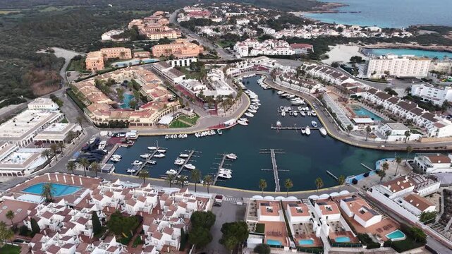 Aerial drone view of Cala en Bosch Marina and Cap d'Artrutx Lighthouse, Menorca, Balearic Islands, Spain