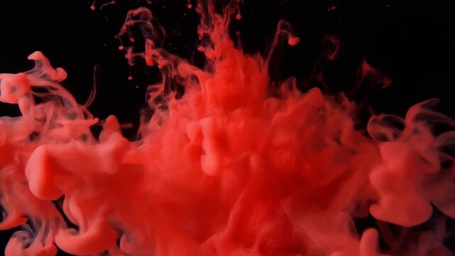 Abstract Red Ink Cloud Swirling in Water on Black Background