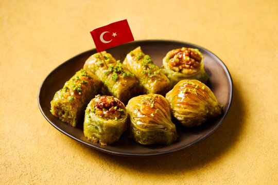 Delicious oriental sweets on plate representing famous Turkey culinary food culture. Yellow background. Close up