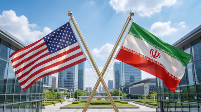 United States and Iran National Flags Flying in Front of Modern Glass Office Buildings Representing International Diplomacy and Relations
