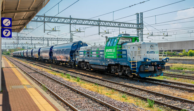 Fossano, Italy &mdash; July 30, 2026: modern CZ Loko EffiShunter 1000 diesel-electric locomotive, operated by the private freight company EVM Rail, pulls a long convoy of blue VTG hopper wagons