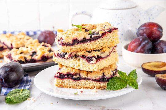 Traditional German Zwetschgenkuchen, plum open pie with crumbled streusel dough topping. Sweet autumn seasonal sweet shortcrust fruit cake