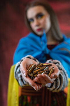 Portrait of sad Ukrainian woman wear national clothes with blue and yellow flag