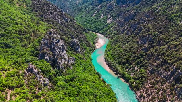 Aerial drone view of the turquoise Verdon River flowing through the Verdon Gorge river canyon in the Provence-Alpes-Cote d'Azur region of southeastern France. High quality 4k footage