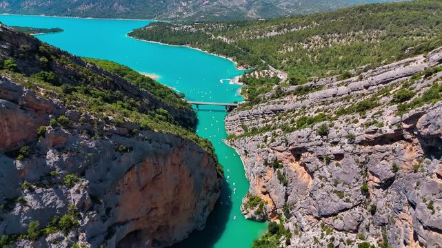 Aerial drone view of the turquoise Verdon River flowing through the Verdon Gorge river canyon in the Provence-Alpes-Cote d'Azur region of southeastern France. High quality 4k footage
