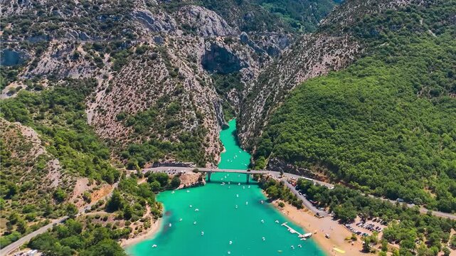Aerial drone view of the turquoise Verdon River flowing through the Verdon Gorge river canyon in the Provence-Alpes-Cote d'Azur region of southeastern France. High quality 4k footage