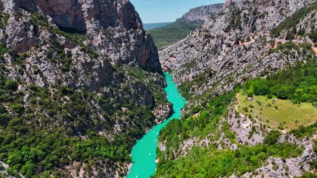 Aerial drone view of the turquoise Verdon River flowing through the Verdon Gorge river canyon in the Provence-Alpes-Cote d'Azur region of southeastern France. High quality 4k footage
