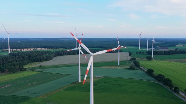 Wind mill for renewable electric energy production. Windmill in a rural area. Offshore wind park. Wind turbines farm. Alternative renewable energy generation. Green energy concept