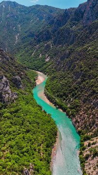Aerial drone view of the turquoise Verdon River flowing through the Verdon Gorge river canyon in the Provence-Alpes-Cote d'Azur region of southeastern France. High quality 4k footage