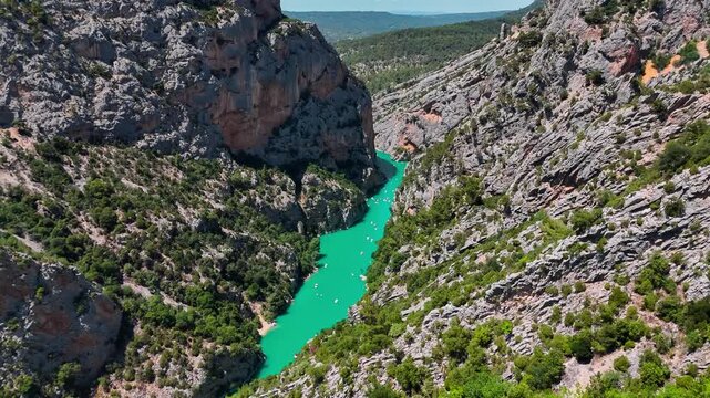 Aerial drone view of the turquoise Verdon River flowing through the Verdon Gorge river canyon in the Provence-Alpes-Cote d'Azur region of southeastern France. High quality 4k footage