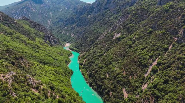 Aerial drone view of the turquoise Verdon River flowing through the Verdon Gorge river canyon in the Provence-Alpes-Cote d'Azur region of southeastern France. High quality 4k footage