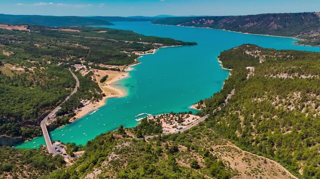 Aerial drone view of the turquoise Verdon River flowing through the Verdon Gorge river canyon in the Provence-Alpes-Cote d'Azur region of southeastern France. High quality 4k footage