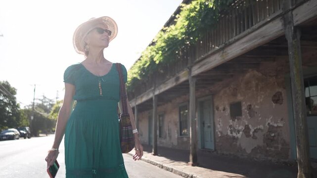 Mature woman visits the historic Blue Wing Inn museum in Sonoma California while enjoying the beautiful surroundings on a sunny day