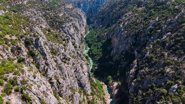 Aerial drone view of the turquoise Verdon River flowing through the Verdon Gorge river canyon in the Provence-Alpes-Cote d'Azur region of southeastern France. High quality 4k footage