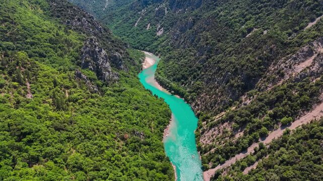 Aerial drone view of the turquoise Verdon River flowing through the Verdon Gorge river canyon in the Provence-Alpes-Cote d'Azur region of southeastern France. High quality 4k footage