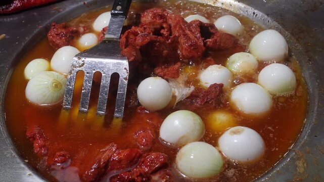 Marinated Meat and White Onions Cooking on Traditional Mexican Taco Stand Griddle