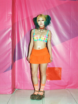 Punk Fashion Portrait of Woman Against Pink Background