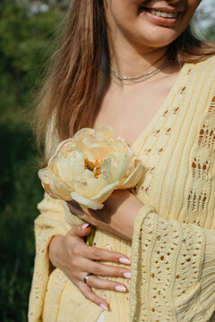 Smiling anonymous woman with matching flower and clothes