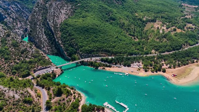 Aerial drone view of the turquoise Verdon River flowing through the Verdon Gorge river canyon in the Provence-Alpes-Cote d'Azur region of southeastern France. High quality 4k footage